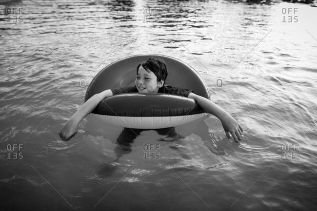 Boy floating in a life ring in a swimming pool
