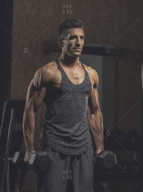 Premium Photo | A handsome man is admiring his muscles at the gym  generative AI