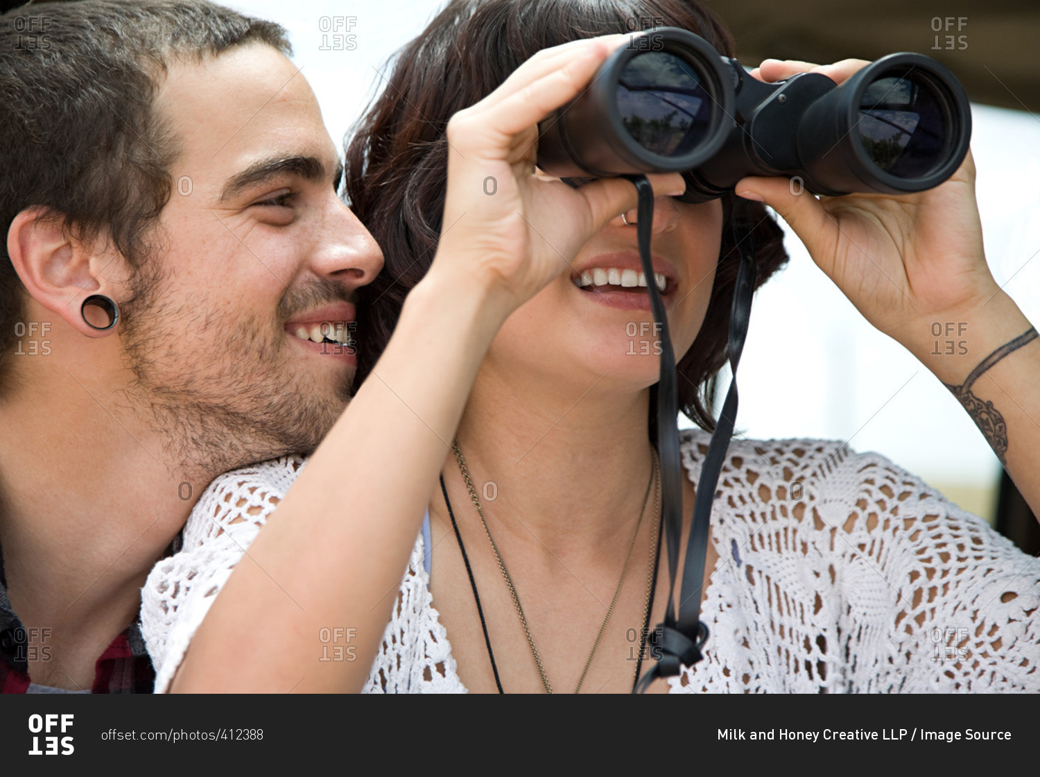 Young couple with binoculars