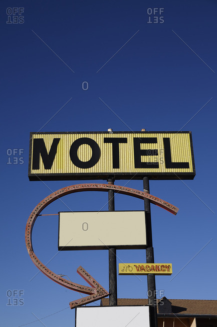 Old roadside motel sign and arrow stock photo - OFFSET