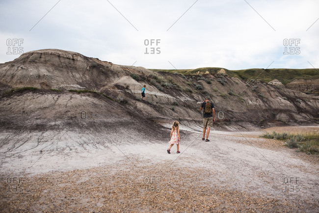 Family walking along a barren hillside
