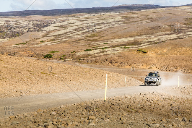 Kjolur highlands, Iceland - August 20, 2014: 4WD vehicle at speed on remote gravel road