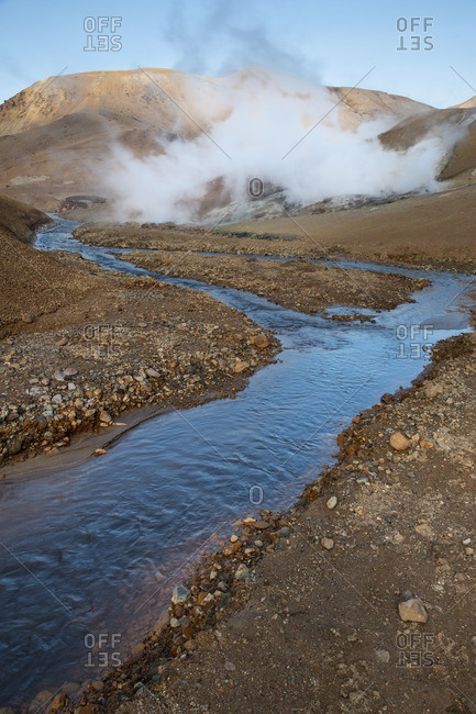 Steam rising along a river in Icelandic geothermal landscape in the remote Kjoslur highlands