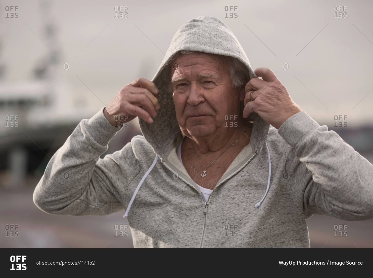 Man wearing hooded top looking at camera