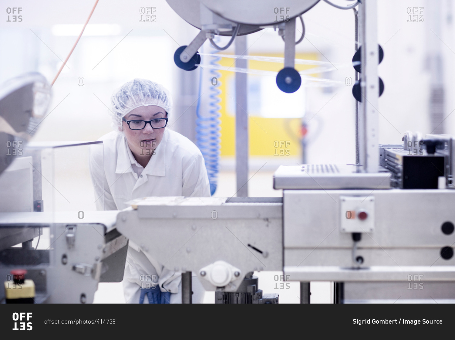 Factory worker operating food production machinery