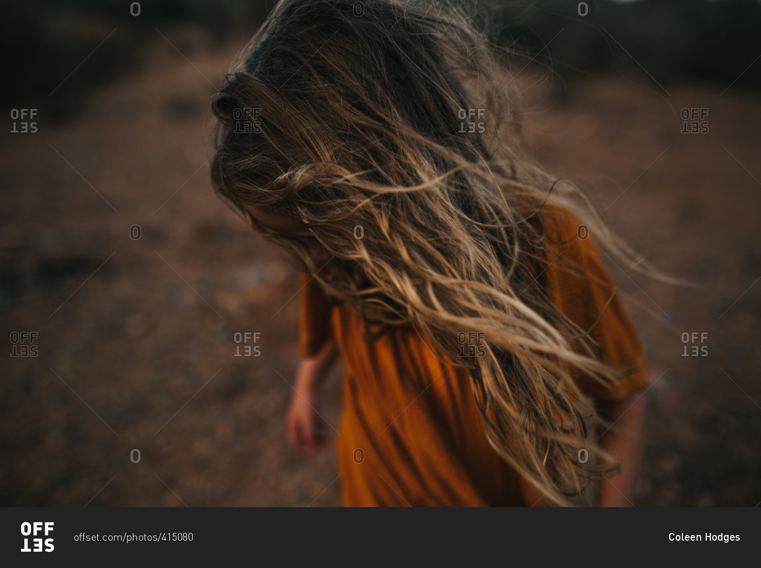 Girl with hair covering her face stock photo - OFFSET