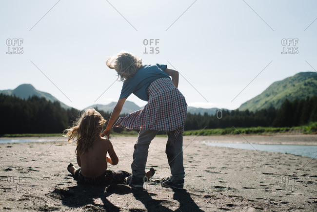 Girl and boy on wilderness beach