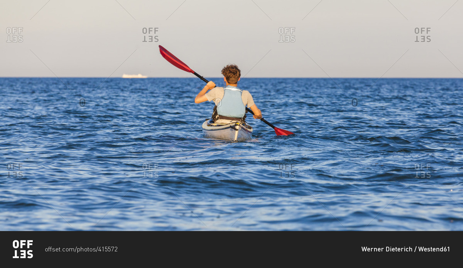 Denmark, Young man kayaking