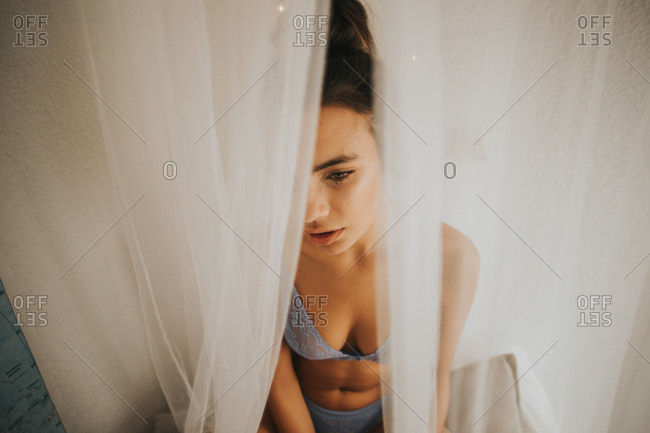 View from behind a woman wearing underwear at an open window stock photo -  OFFSET