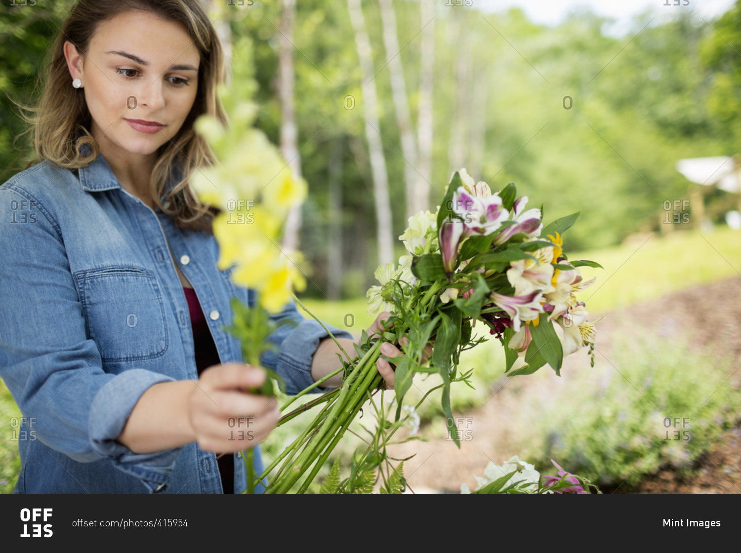 A woman holding a bunch of summer garden flowers