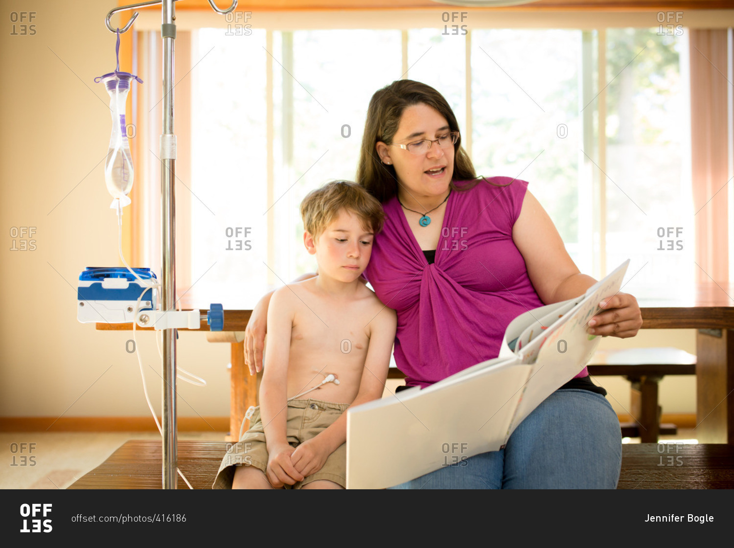 Mother By Boy Porn - Mom reading to boy using gastric tube stock photo - OFFSET