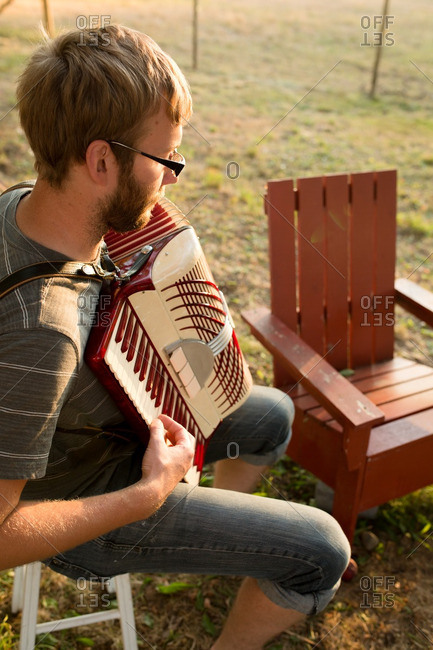 Man playing accordion outside