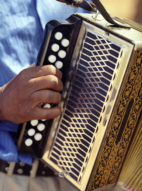 Hands of a man playing an accordion in the Cape Verde Islands