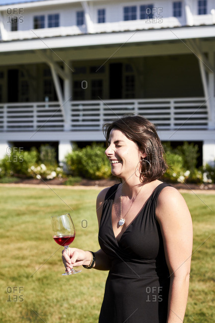 Woman outside holding a glass of wine