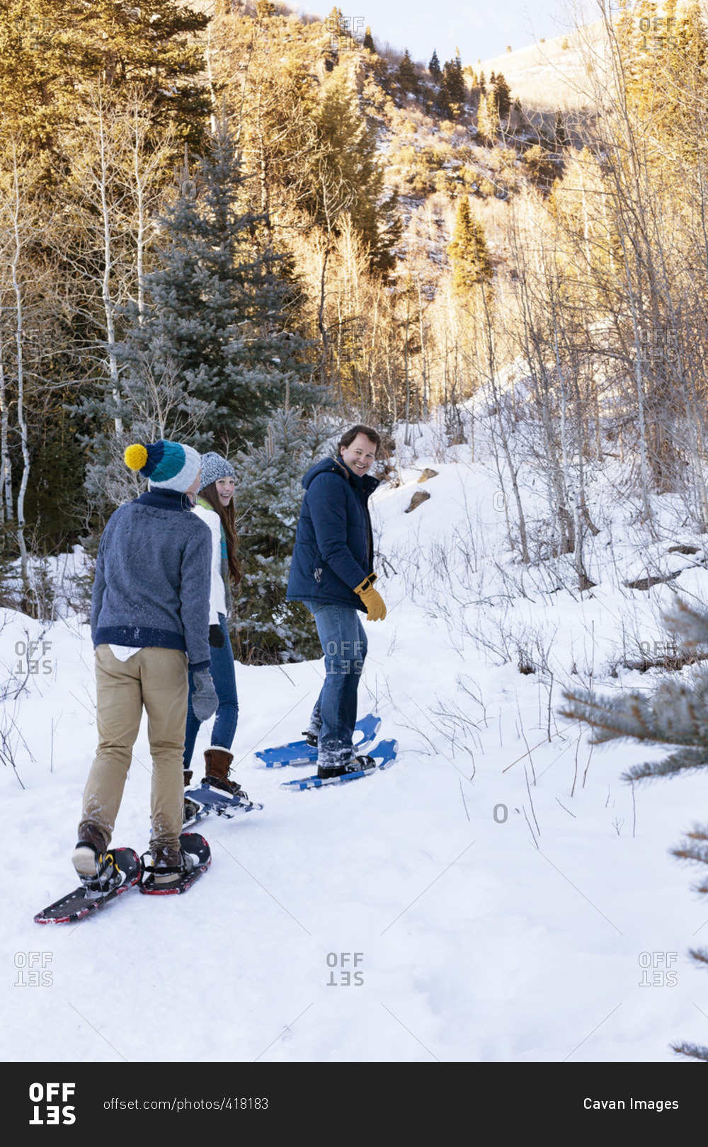 Happy family snowboarding on snowy field