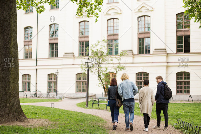 Group of college students walking on campus together