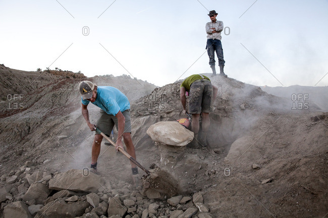 Kaiparowits, Utah, USA - September 20, 2015: Three paleontologists work an excavation site in Utah's Kaiparowits Plateau