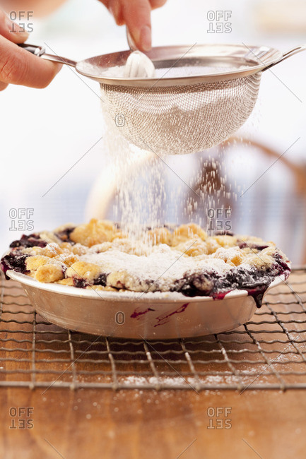Dust little blueberry pie with icing sugar