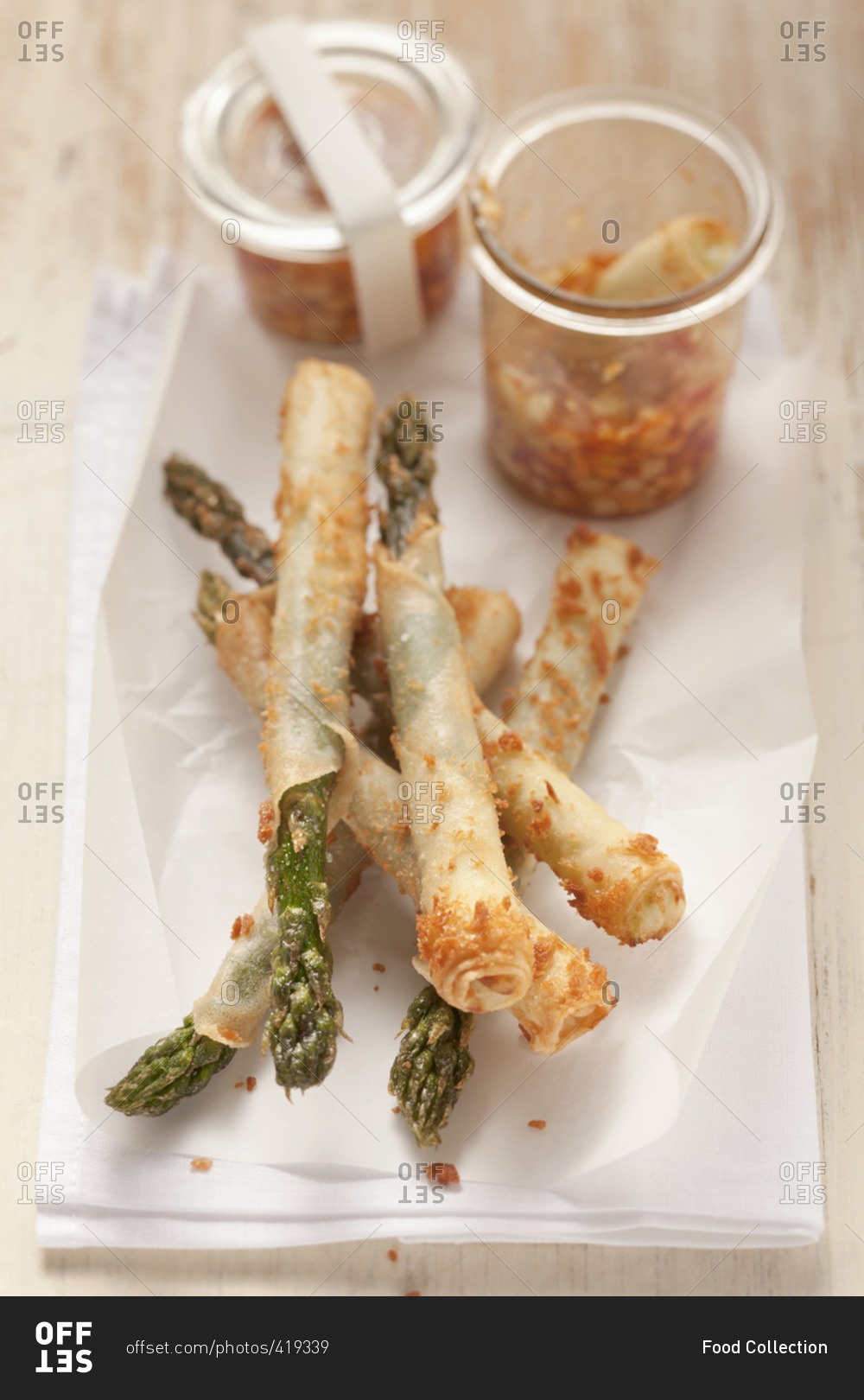 Green asparagus in spring roll pastry with a chili, cucumber and peanut dip