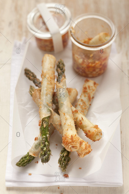 Green asparagus in spring roll pastry with a chili, cucumber and peanut dip