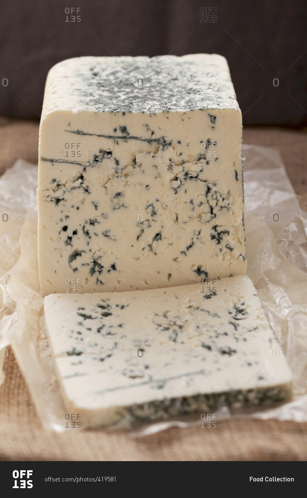 Blue cheese, partly slices, on paper