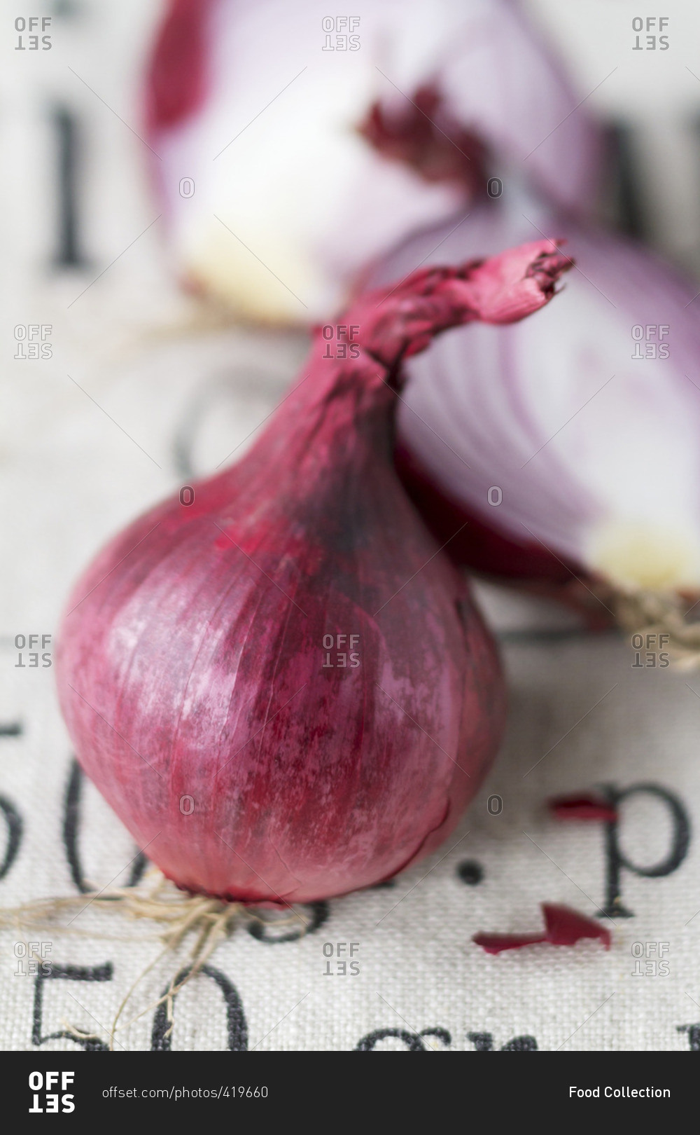 A halved and a whole red onion