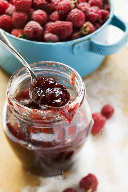 Jar of raspberry jam, sugar and fresh raspberries