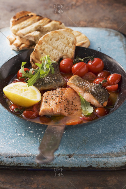 Fried fish fillets with oven roasted tomatoes and toast
