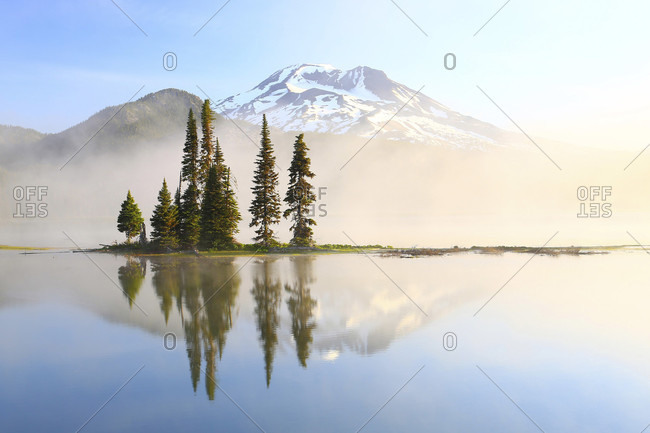 Reflection Of Tree And Mountain In Sparks Lake During Sunrise