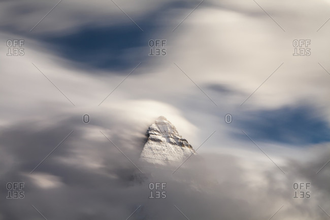 Peak Of Mount Assiniboine Among The Clouds In British Columbia, Canada