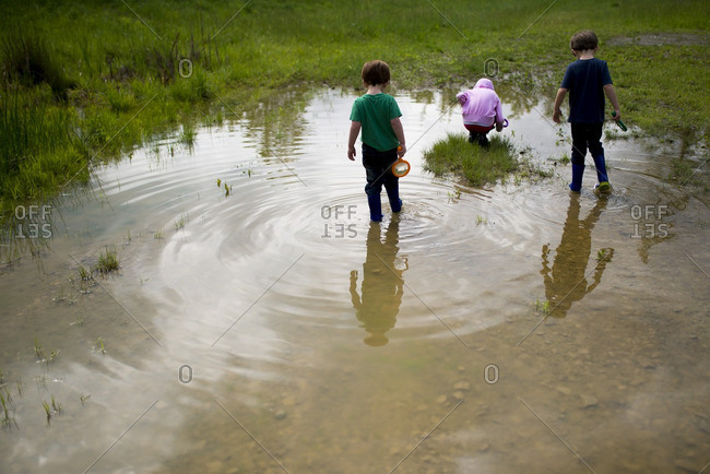 Kids playing in a wet field