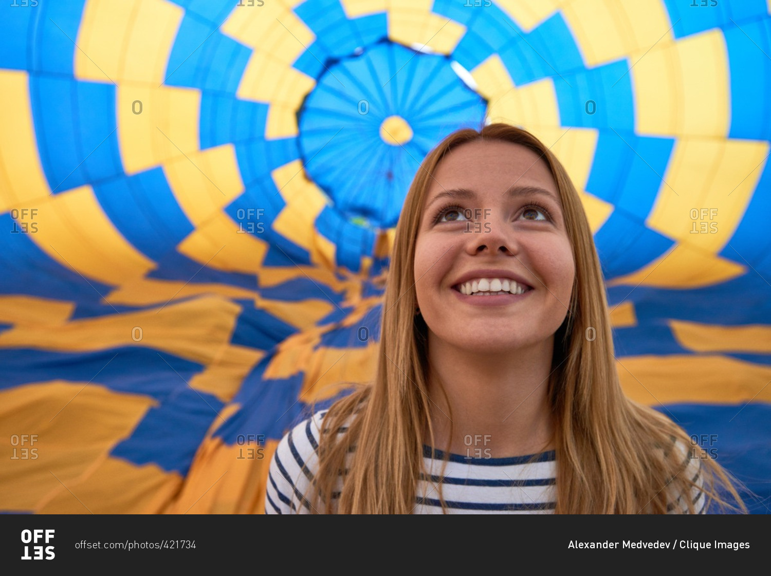 Portrait of young girl against hot air balloon