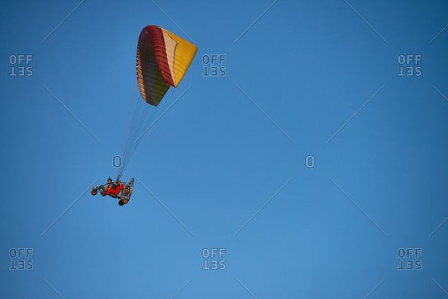 Two men driving powered paraglider