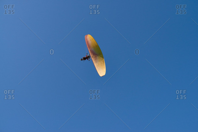 Two men driving powered paraglider