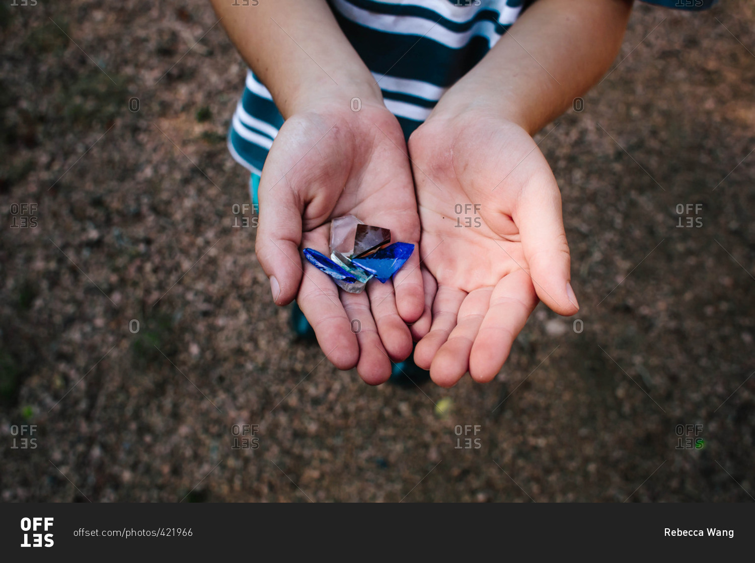 child-holding-pieces-of-broken-glass-stock-photo-offset