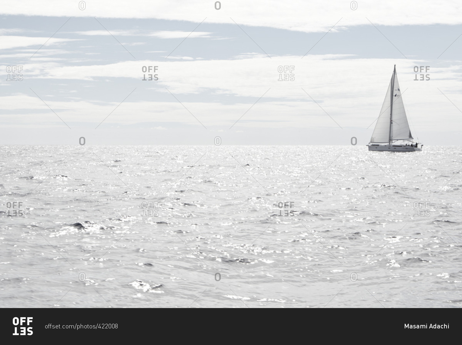 Monochromatic scene of a sailing yacht on the ocean at mid day