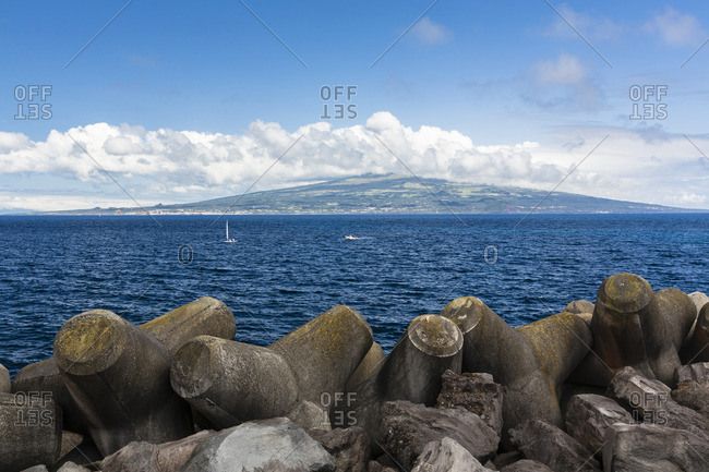 Concrete Wave Breakers with Sailing Boats and Pico Island in the distance, Horta, Faial Island, Azores, Portugal