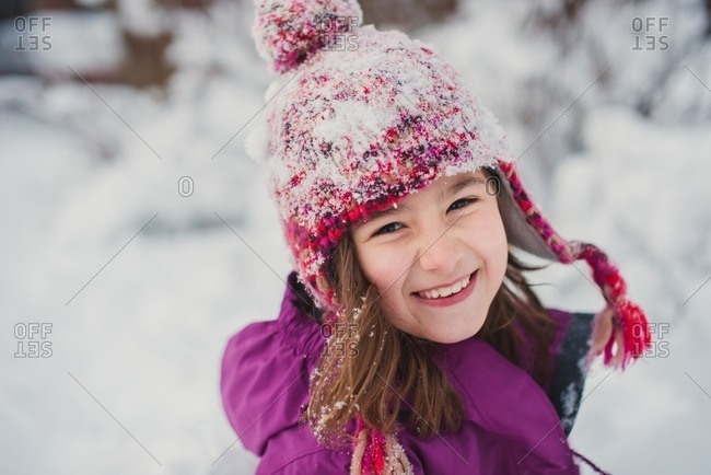 Portrait of a smiling girl standing in the snow