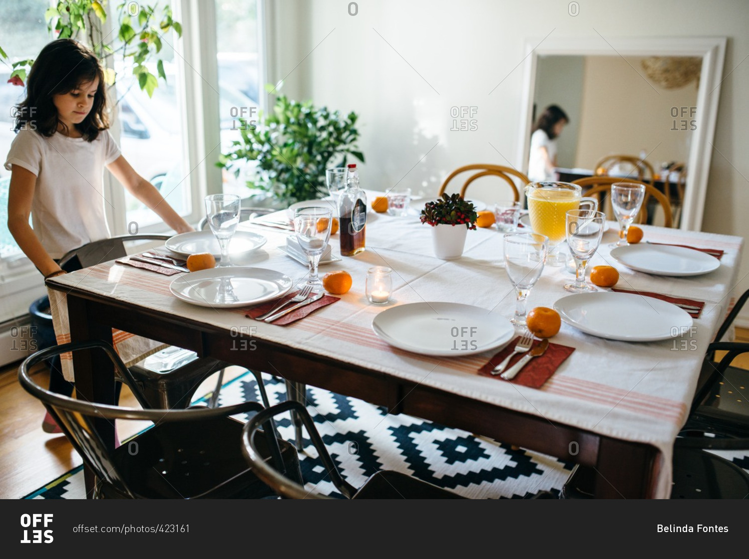 Girl at a dining table set for Christmas breakfast