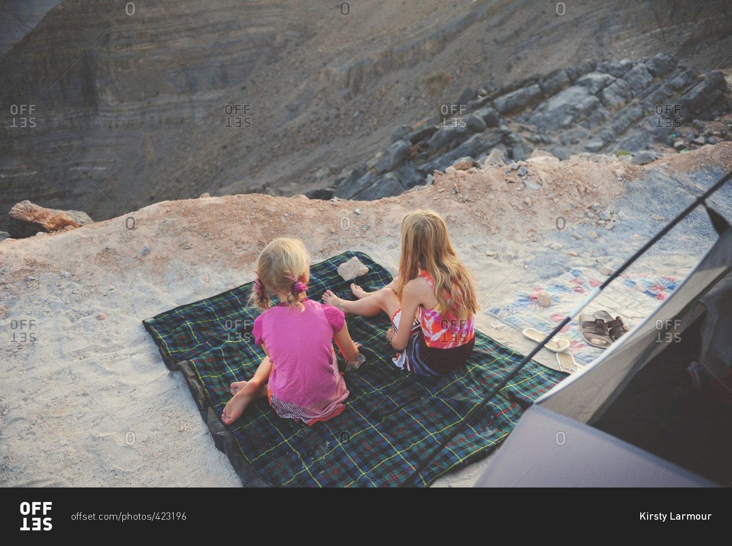 Girls camping in rugged mountains