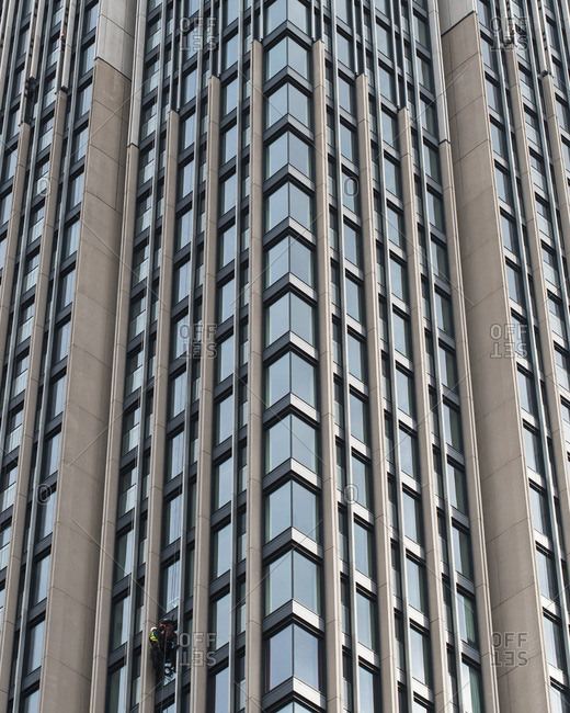 Window cleaners working on facade of skyscraper