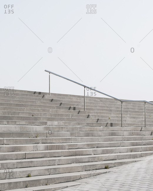 Set of cement stairs with railing in middle