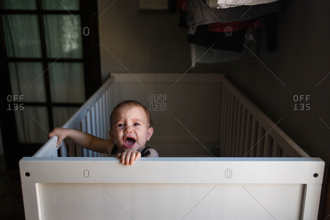 Crying Baby Standing Up In Crib Stock Photo Offset