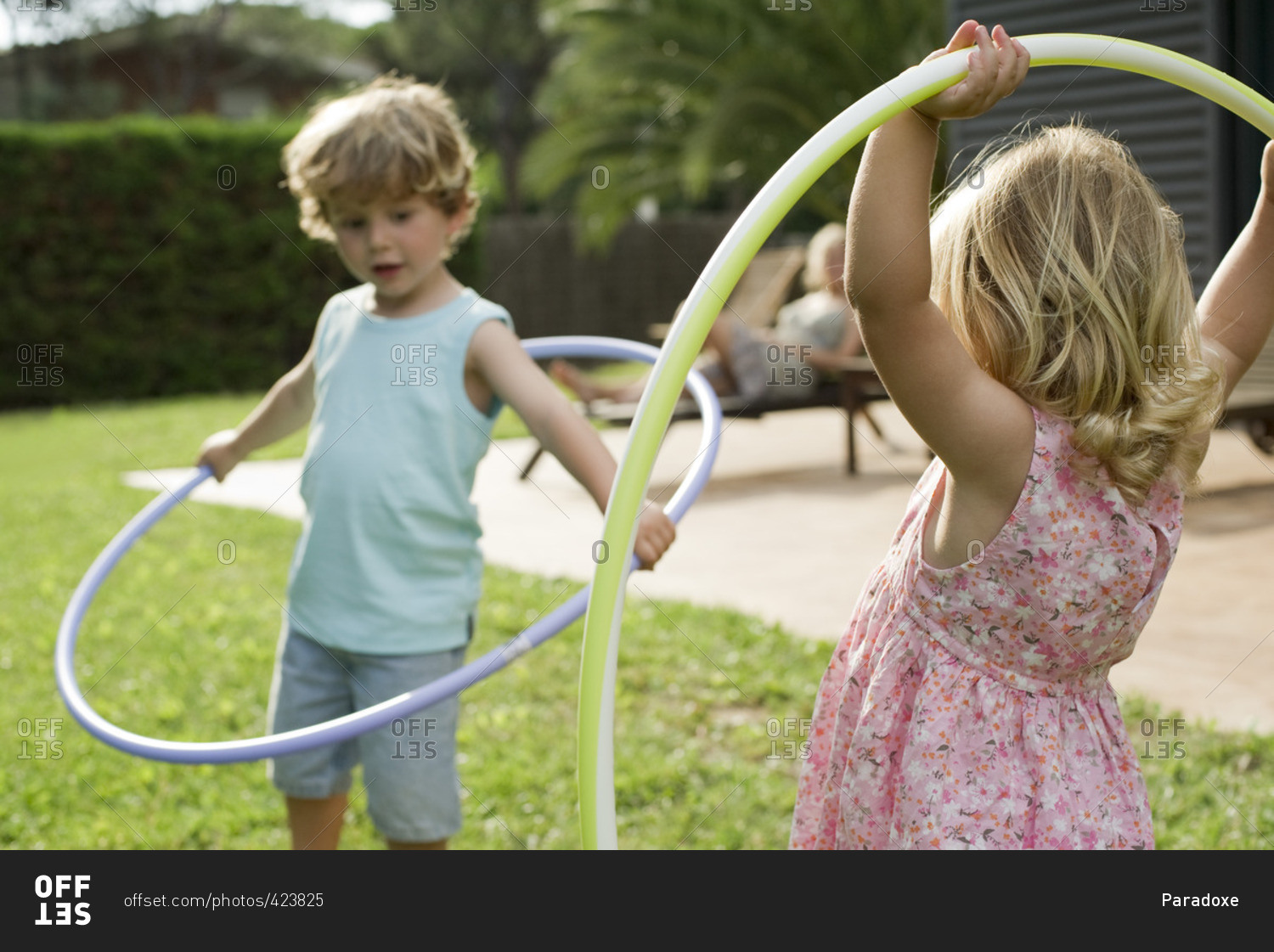 Children playing with plastic hoops outdoors