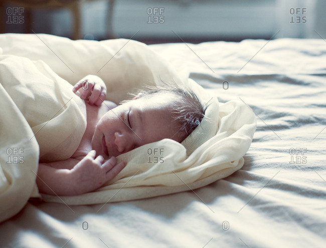 New born baby sleeping in bed