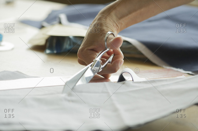 Woman cutting fabric, cropped - Offset