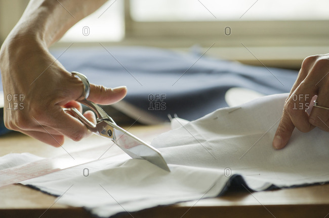 Woman cutting fabric, cropped - Offset