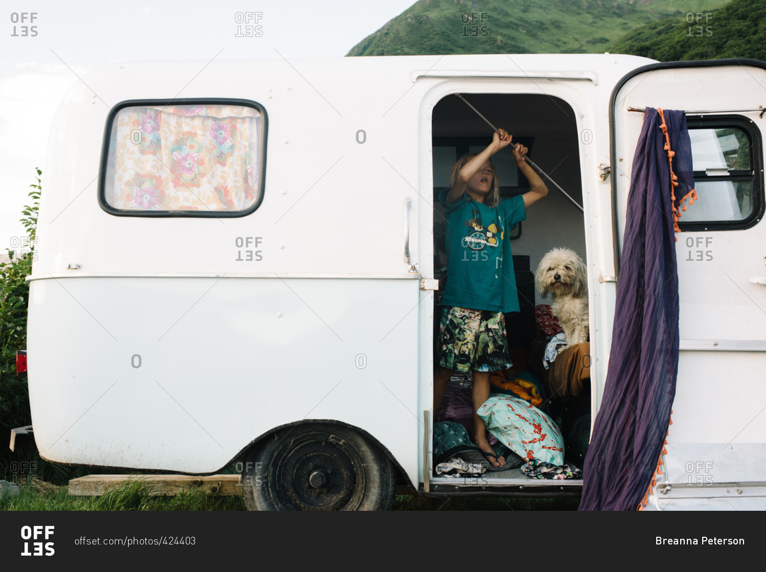 Boy in camper trailer doorway