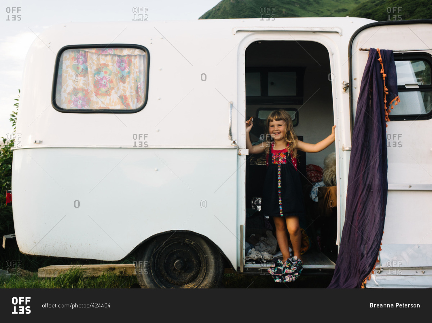Girl in door of camper trailer