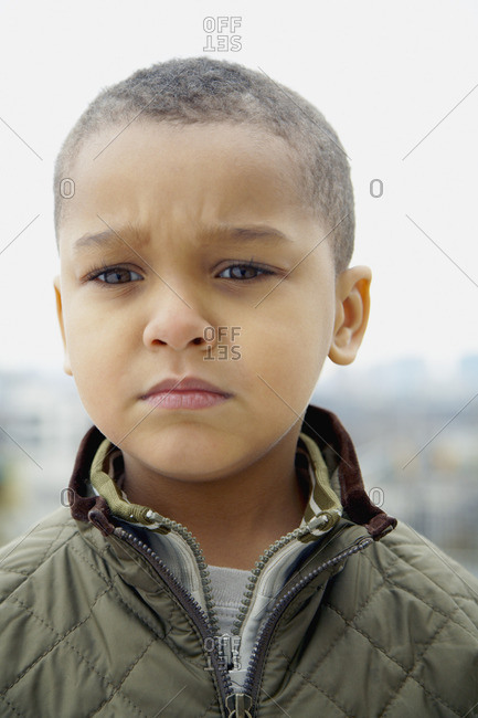 Mixed race boy frowning - Offset